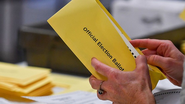 In this November 2023 photo, a woman takes a mail-in ballot from an envelope at a polling station in Pennsylvania.
Mandatory Credit:	Aimee Dilger/SOPA Images/Getty Images via CNN Newsource