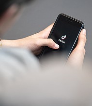 A teenager looks at a smartphone with the TikTok logo displayed. A bipartisan group of 14 attorneys general from across the country filed lawsuits on October 8 against TikTok, alleging that the platform has “addicted” young people and harmed their mental health.
Mandatory Credit:	Hannes P. Albert/dpa/picture alliance/Getty Images via CNN Newsource