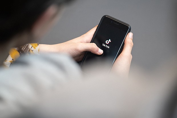 A teenager looks at a smartphone with the TikTok logo displayed. A bipartisan group of 14 attorneys general from across the country filed lawsuits on October 8 against TikTok, alleging that the platform has “addicted” young people and harmed their mental health.
Mandatory Credit:	Hannes P. Albert/dpa/picture alliance/Getty Images via CNN Newsource