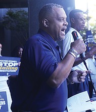 Brian Peyton, center, president of Teamsters 322, addresses a crowd from the back steps of Richmond City Hall on
Tuesday, Oct. 8. Speaking on behalf of City of Richmond city workers, Peyton criticized Mayor Levar M. Stoney’s administration for not taking labor negotiations seriously.