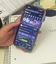 A sports bettor uses a mobile app to place a wager, highlighting the convenience and growing popularity of sports betting in Virginia, where it generated nearly $69 million in taxes in 2023.
