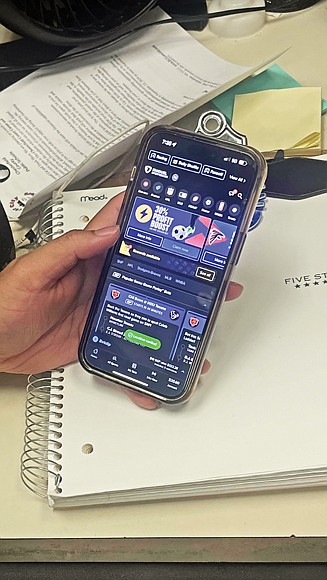 A sports bettor uses a mobile app to place a wager, highlighting the convenience and growing popularity of sports betting in Virginia, where it generated nearly $69 million in taxes in 2023.