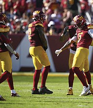 Washington Commanders linebacker Dante Fowler Jr., right, celebrates his sack last Sunday of Cleveland Browns quarterback Deshaun Watson (not shown) during the second half of the game in Landover, Md.