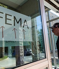 A resident enters a FEMA improvised station to attend claims by local residents affected by floods following the passing of Hurricane Helene, in Marion, North Carolina, on October 5.
Mandatory Credit:	Eduardo Munoz/Reuters via CNN Newsource