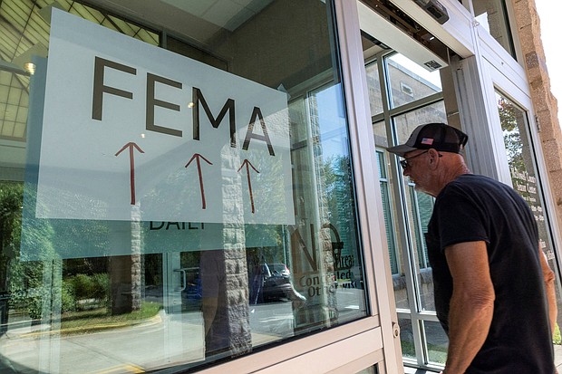 A resident enters a FEMA improvised station to attend claims by local residents affected by floods following the passing of Hurricane Helene, in Marion, North Carolina, on October 5.
Mandatory Credit:	Eduardo Munoz/Reuters via CNN Newsource