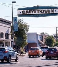The new Carytown sign, installed above Cary Street near Kroger, marks the entrance to the shopping district. The project, completed after a two-year collaboration between the city, Carytown Merchants Association and 5th District Councilperson Stephanie Lynch, is suspended approximately 25 feet overhead.