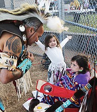 Pernell Richardson of Richmond checks on his granddaughters before showcasing his traditional Nansemond Tribal
dancing during The Pocahontas Project’s Indigenous Peoples’ Day celebration Monday, Oct. 14, at Powhatan Hill Park.