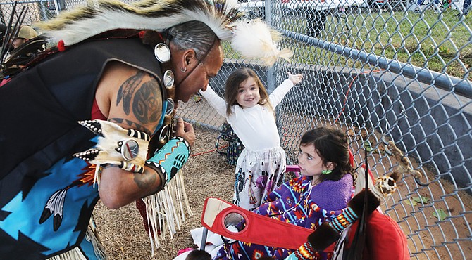 Pernell Richardson of Richmond checks on his granddaughters before showcasing his traditional Nansemond Tribal
dancing during The Pocahontas Project’s Indigenous Peoples’ Day celebration Monday, Oct. 14, at Powhatan Hill Park.