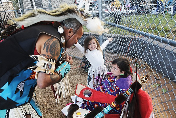 Pernell Richardson of Richmond checks on his granddaughters before showcasing his traditional Nansemond Tribal
dancing during The Pocahontas Project’s Indigenous Peoples’ Day celebration Monday, Oct. 14, at Powhatan Hill Park.