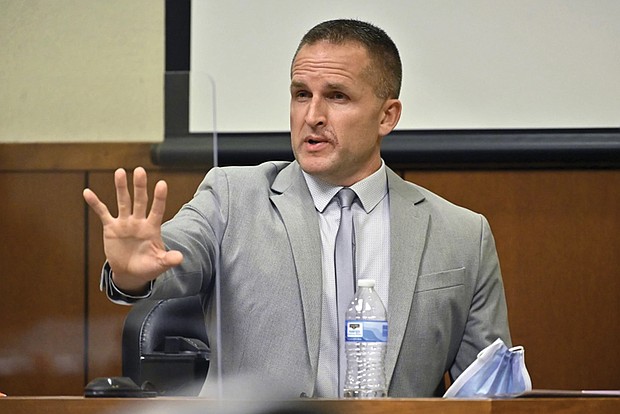 Former Louisville Police officer Brett Hankison responds to his defense attorney March 2, in Louisville, Ky.