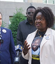 Caroline Ouko, mother of Irvo Otieno, speaks as attorney Mark Krudys and others look on Monday during a press conference calling for a U.S. Department of Justice investigation into Otieno’s death outside the U.S. District Courthouse at 701 E. Broad St.