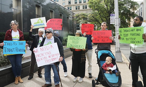 Tenants and allies facing issues with their landlords listen Tuesday to speakers during a Virginia Organizing press conference outside Richmond City Hall.