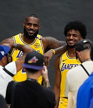 Los Angeles Lakers' LeBron James, left, and his son, Bronny James, could make history Tuesday as first father-son duo to play together in a regular season NBA game.
Mandatory Credit:	Jae C. Hong/AP via CNN Newsource