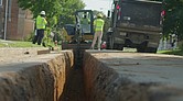 Construction workers dig up legacy gas lines to replace them with more durable materials.