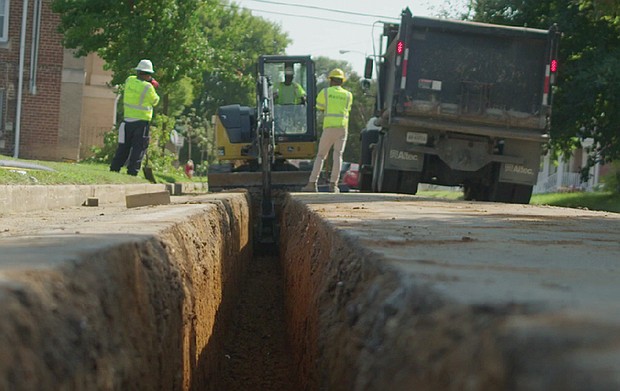 Construction workers dig up legacy gas lines to replace them with more durable materials.