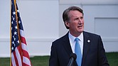 Virginia Gov. Glenn Youngkin speaks to reporters outside the Capitol during the 2024 General Assembly session.