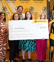 Baker Ripley and Los Defensores Representatives During Check Presentation at Xochi Restaurant in Downtown Houston