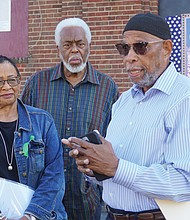 From left, Viola Baskerville, Leonard Edloe and Gary Flowers look on as Sa’ad El-Amin, center, speaks during a press conference Tuesday on a lawsuit seeking to prevent Virginia Union University’s demolition of the Richmond Community Hospital building on the hospital’s front lawn.