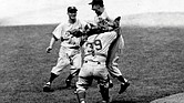 Brooklyn Dodgers pitcher Johnny Podres is lifted by catcher Roy Campanella (39) after the final out of the seventh and deciding game of the World Series at Yankee Stadium, Oct. 4, 1955, in New York.