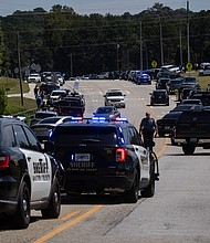 Authorities found documents that they believe reference past school shootings in the home of the 14-year-old accused of shooting at Apalachee High School, and law enforcement are pictured after the shooting in Winder, Georgia, on September 4.
Mandatory Credit:	Christian Monterrosa/AFP/Getty Images via CNN Newsource