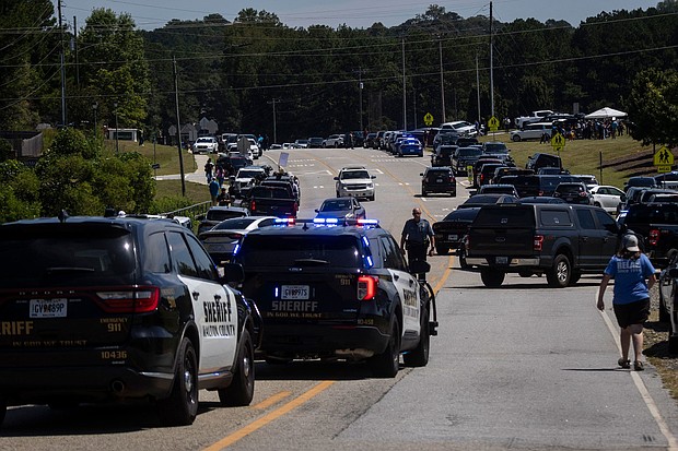 Authorities found documents that they believe reference past school shootings in the home of the 14-year-old accused of shooting at Apalachee High School, and law enforcement are pictured after the shooting in Winder, Georgia, on September 4.
Mandatory Credit:	Christian Monterrosa/AFP/Getty Images via CNN Newsource