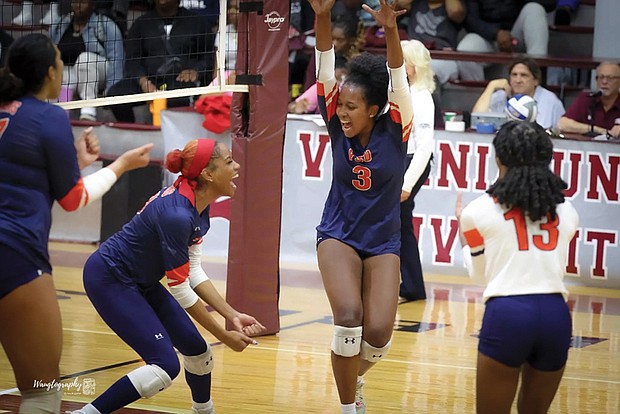 Virginia State players celebrate a key point during a recent match. The Trojans’ teamwork led them to a weekend sweep over Lincoln and Shaw, snapping Shaw’s conference winning streak.