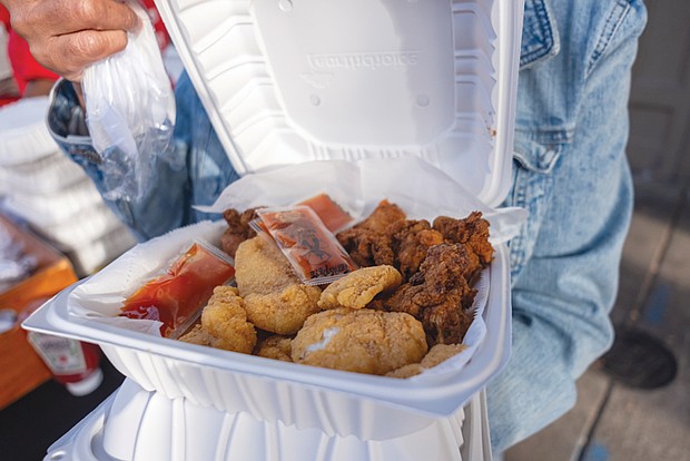 Sandra Tatum displays some of the food served at the block party. The menu featured Soul Food and Southern cuisine.