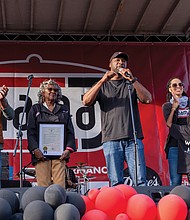 Mayor Levar M. Stoney left, issues a proclamation making Oct. 27 Mama J’s Day while the Johnson Family joins him on stage. They are from left, co-owners Velma and Lester Johnson, his wife, Yolanda Johnson, and their daughter Lena.