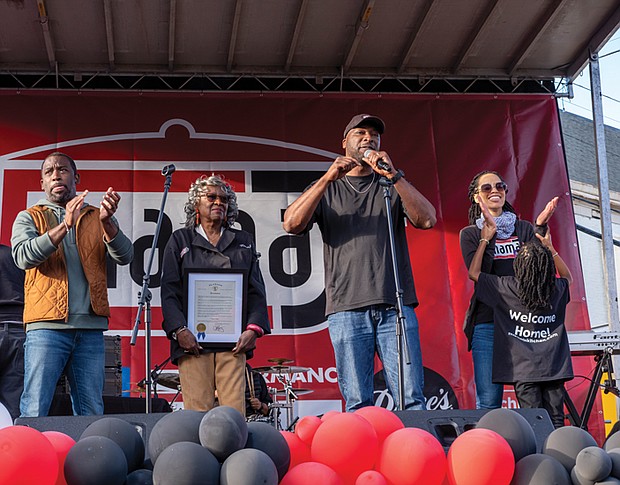 Mayor Levar M. Stoney left, issues a proclamation making Oct. 27 Mama J’s Day while the Johnson Family joins him on stage. They are from left, co-owners Velma and Lester Johnson, his wife, Yolanda Johnson, and their daughter Lena.