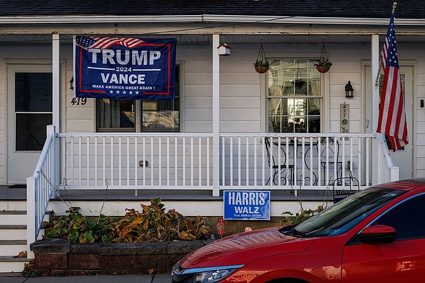 A Trump/Vance campaign flag hangs in front of one side of a duplex home while a Harris/Walz campaign sign is seen in front of the other side in Pen Argyl, Pennsylvania on November 2.
Mandatory Credit:	Samuel Corum/AFP/Getty Images via CNN Newsource