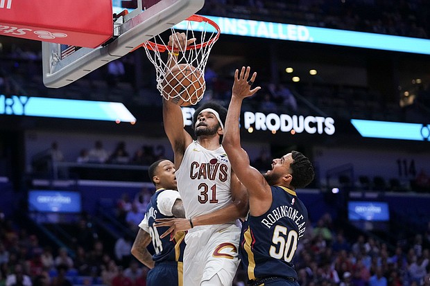 Cleveland Cavaliers center Jarrett Allen dunks between New Orleans Pelicans forward Jeremiah Robinson-Earl and guard Jordan Hawkins in the first half at Smoothie King Center.
Mandatory Credit:	Gerald Herbert/AP via CNN Newsource