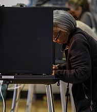 Joyce Banks casts her vote on Tuesday, Nov. 5 at John B. Cary Elementary School in the Byrd Park neighborhood.