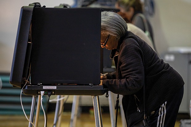 Joyce Banks casts her vote on Tuesday, Nov. 5 at John B. Cary Elementary School in the Byrd Park neighborhood.