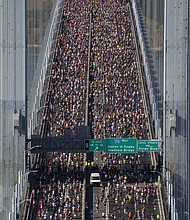 New York City Marathon runners cross the Verrazzano-Narrows Bridge on November 3.
Mandatory Credit:	Craig T Fruchtman/Getty Images via CNN Newsource