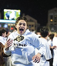 Colorado fans storm the playing field after Colorado’s overtime victory over Baylor in an NCAA college football game Saturday, Sept. 21, in Boulder, Colo.