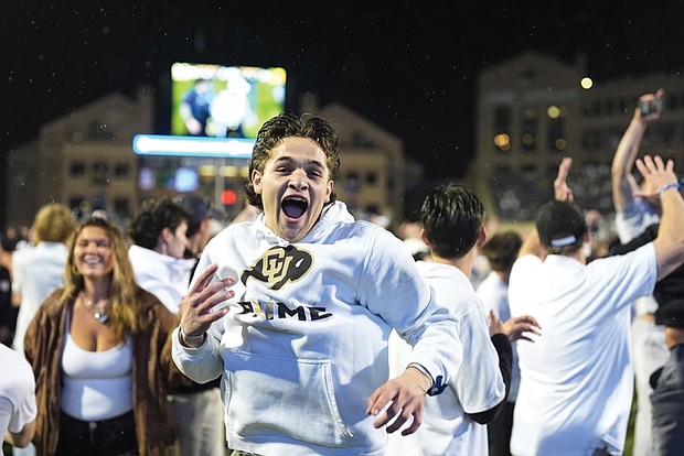 Colorado fans storm the playing field after Colorado’s overtime victory over Baylor in an NCAA college football game Saturday, Sept. 21, in Boulder, Colo.