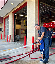 Firefighter Garcia at Station 23 with one of Councilmember Martinez's children.