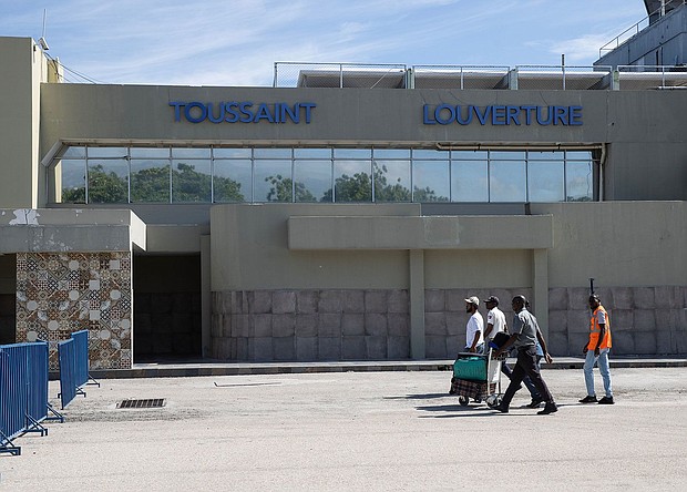 Travelers walk in front of the Toussaint Louverture International Airport in Port-au-Prince in May 2024.
Mandatory Credit:	Orlando Barria/EPA-EFE/Shutterstock/File via CNN Newsource