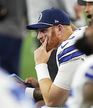 Dallas Cowboys quarterback Cooper Rush sits on the bench Nov. 10 late in the second half of an NFL game against the Philadelphia Eagles in Arlington, Texas.