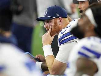 Dallas Cowboys quarterback Cooper Rush sits on the bench Nov. 10 late in the second half of an NFL game against the Philadelphia Eagles in Arlington, Texas.