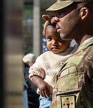 Capt. Stanthony Nelms holds his daughter, Harley Nelms, 1, during the Commonwealth’s Veterans Day Ceremony at the Virginia War Memorial on Monday, Nov. 11. Nelms is the commanding captain of the U.S. Army’s Golf Company, 244th Quartermaster Battalion, which attended the ceremony.