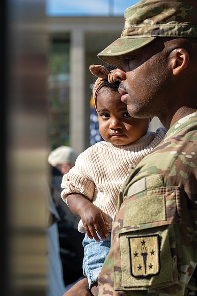 Capt. Stanthony Nelms holds his daughter, Harley Nelms, 1, during the Commonwealth’s Veterans Day Ceremony at the Virginia War Memorial on Monday, Nov. 11. Nelms is the commanding captain of the U.S. Army’s Golf Company, 244th Quartermaster Battalion, which attended the ceremony.