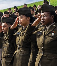 U.S. Army Golf Company, 244th Quartermaster Battalion members Genesis Simmons, right, Mary Hagy, and Keith Pirtle salute the flag during the national anthem.