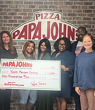 Representatives from the Youth Business Exchange celebrate receiving a $5,000 grant from the Papa Johns Foundation for Building Community supporting youth entrepreneurship programs in Richmond.