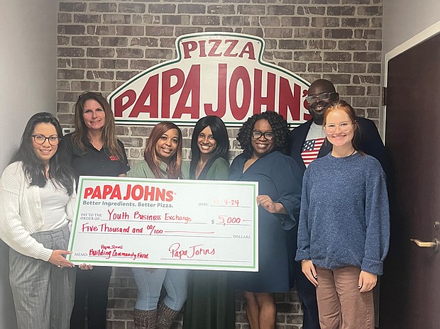 Representatives from the Youth Business Exchange celebrate receiving a $5,000 grant from the Papa Johns Foundation for Building Community supporting youth entrepreneurship programs in Richmond.