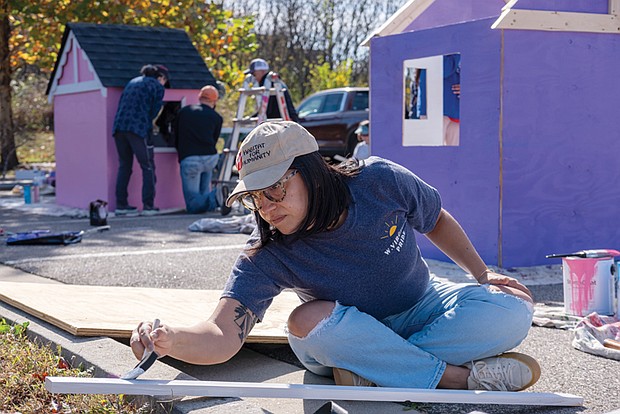 LuLu Fiscella paints for Richmond Metropolitan Habitat for Humanity’s Project Playhouse, which brought together sponsors to build playhouses for local children Nov. 9 and Nov. 10 in the Stone Brewing parking lot. The project works to provide children with a safe space to play, dream and explore in their own playhouse.