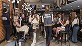 RVA Fashion Week’s 2023 Model of the Year, Diamond Minnetta, (left) closes the Urban Academy’s “Varsity Club” Fashion Show on Monday night at Brickwood Barbecue. photo Julianne Tripp Hillian