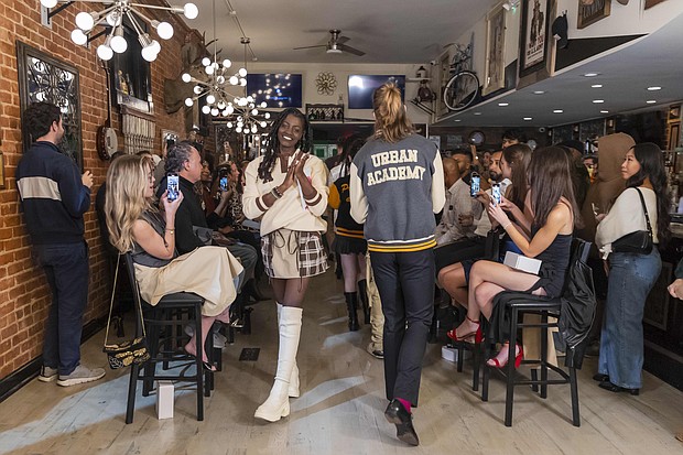 RVA Fashion Week’s 2023 Model of the Year, Diamond Minnetta, (left) closes the Urban Academy’s “Varsity Club” Fashion Show on Monday night at Brickwood Barbecue. photo Julianne Tripp Hillian