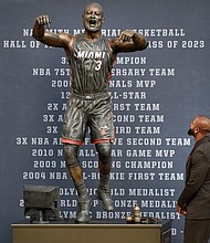 Wade looks at his bronze statue at the unveiling ceremony.
Mandatory Credit:	Michael Laughlin/AP via CNN Newsource