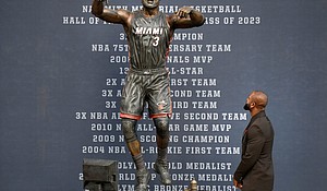 Wade looks at his bronze statue at the unveiling ceremony.
Mandatory Credit:	Michael Laughlin/AP via CNN Newsource